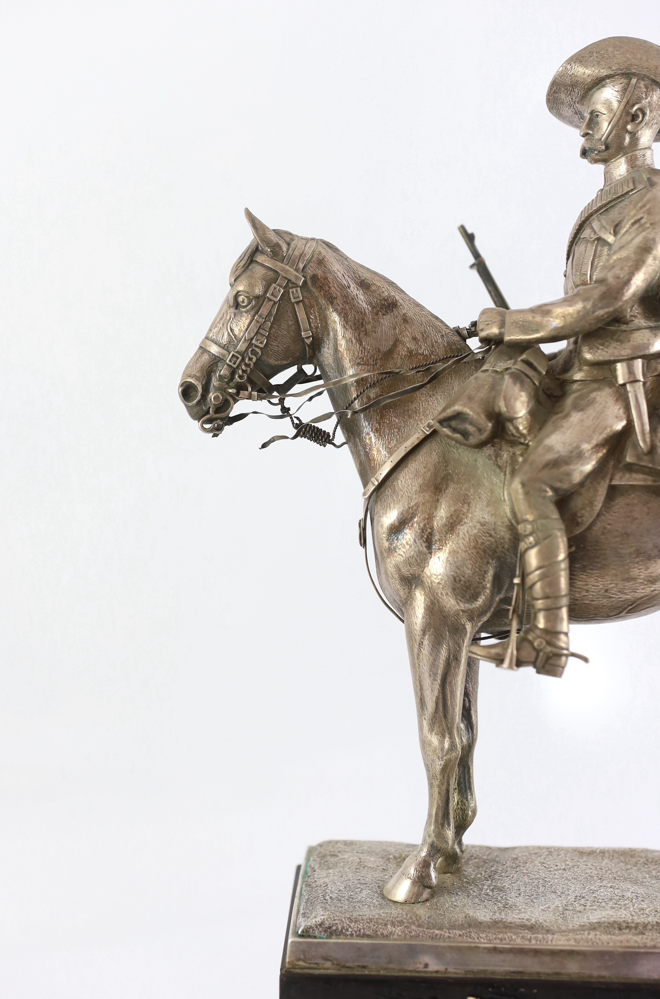 An early 20th century silver model of a City Imperial Volunteer, holding a rifle, on horseback, early 20th century